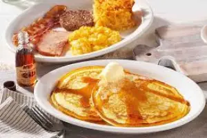 "Cracker Barrel breakfast menu with hearty Southern options like Old Timer’s Breakfast, pancakes, bacon, eggs, biscuits, and hashbrown casserole"

