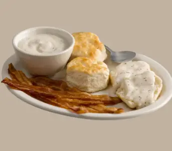 “Biscuit and gravy served with bacon or sausage at Cracker Barrel breakfast”


