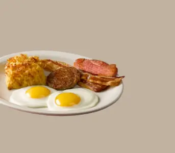“Sunrise Sampler breakfast with eggs, sausage, bacon, and pancakes at Cracker Barrel”

